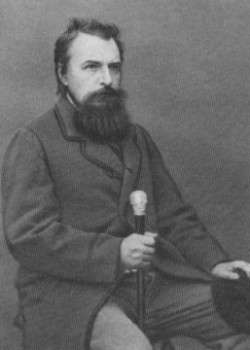 Photo of bearded, seated man holding a cane