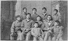 black & white photo of American Indian children in cadet uniforms at Carlisle Indian School