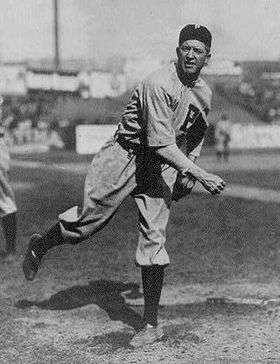 Black and white image of Grover Cleveland Alexander following through after throwing in his Phillies uniform