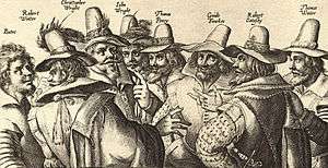 A monochrome engraving of eight men, in 17th-century dress; all have beards, and appear to be engaged in discussion.