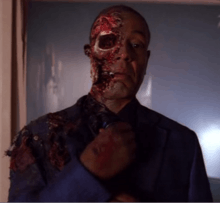 Actor Giancarlo Esposito, portraying Gus Fring on Breaking Bad, in a blue suit with half of his face blown off due to a bomb