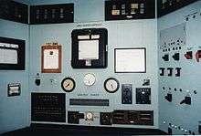 A control panel with lots of switches and meters