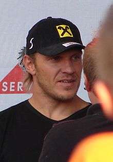 A man wearing a black shirt and hat.