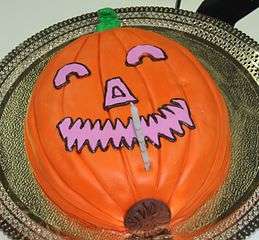 A Halloween cake prepared with the appearance of a jack-o'-lantern