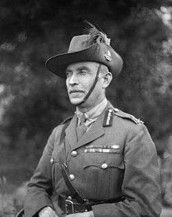 Head and shoulders of man in Army uniform with Sam Brown belt and slouch hat with emu feathers.