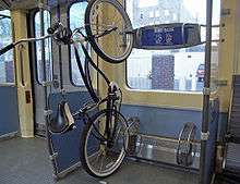 Bike hanging sideways on a rack inside a train