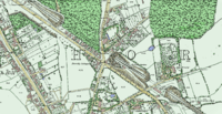 A coloured historic map showing the houses roads and woods around Highgate station, which is located in a cutting