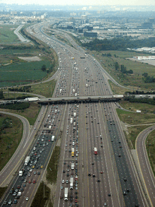"An aerial photo of a wide 18-lane highway."