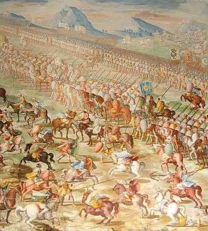 A painting of a battle with a long line of mounted riders side-by-side in front of a line of marching men. In front of the riders are a number of individual horsemen fighting.