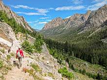 A hiker on a trail in the Sawtooth Wilderness