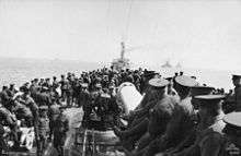 Soldiers standing on the deck of a ship
