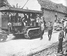Holt tractor in 1916 towing artillery.