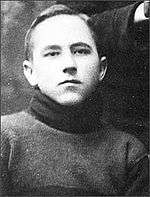 Head and shoulders of unsmiling young man in a turtleneck sweater