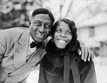 Lead Belly, on the left, with his arm around and Martha.