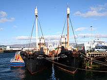 Two moored vessels. Both have significant amounts of rust