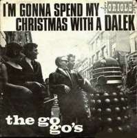 A square record cover, with the text "I'M GONNA SPEND MY CHRISTMAS WITH A DALEK" and the label "ORIOLE" (smaller) above a photograph showing a young woman and four young men in 1960s dress smiling and laughing at a grey Dalek on an urban street. The white text "the go-go's" is superimposed on the lower left quadrant of the photograph.