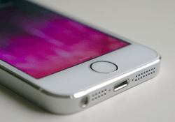 The front of an iPhone 5S show a circular home button.