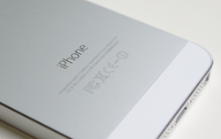 The "iPhone" wordmark on the back of an iPhone 5S.