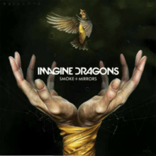Two hands bound by tape release a hummingbird into the air. The dark green background is littered with various lines and geometric shapes with numbers and symbols written into the top of the artwork. The words "Imagine Dragons" and "Smoke + Mirrors" are printed in white at the center of the artwork.