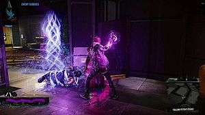 The player character Delsin Rowe has just used his powers to subdue an enemy, who lays restrained on the floor with light particles that resemble chains wrapped around him. The text prompt in the upper-left hand corner reads "Enemy subdued".