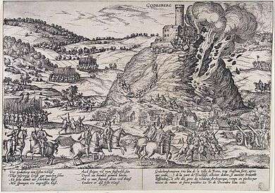  A castle stands at the top of a steep hill, and its walls are being blown away in explosion and fire. The fortress is surrounded by mounted and foot soldiers, and several units of mounted soldiers are racing up the hill toward the castle on its peak. Frans Hogenberg, a Dutch engraver and artist of the 16th century, was living in the Electorate of Cologne during the war, and engraved this picture of the destruction of the Godesburg (fortress).