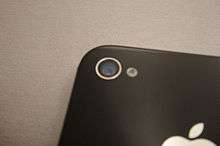 The camera on the back side of the iPhone 4S.