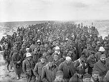 A column of thousands of ragged looking men, stretching all the way to the horizon