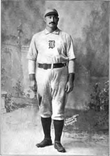 A full body photograph of a baseball player in uniform.