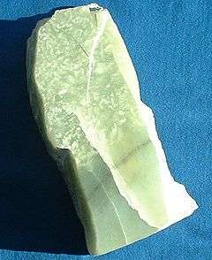 An irregular chunk of celedon green jade.