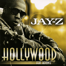 An African-American man is sitting. He wears a dark glasses and a dark jacket with many white stains, and behind him, the background is yellow. Near to him, the word "Jay-Z" is written in white capital letters, "Hollywood" in golden capital letters, and "Feat. Beyoncé" in white over a golden strip.