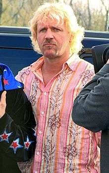 Jeff Jarrett, a blond-haired Caucasian man in a pink shirt