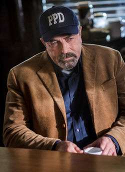 A photo of Tom Selleck wearing a ball cap with the letters PPD