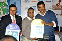 John Abraham smiles with other two men at the camera
