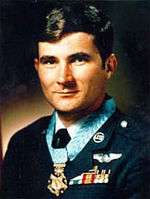 A color image of Levitow wearing his dress military uniform with ribbons and no hat. His Medal of Honor can be seen around his neck.