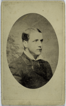 A portrait of a gentleman posing in a suit and facing slightly left.