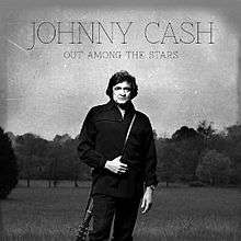 A black-and-white photograph of Cash dressed in black with a guitar slung around his back. The title and artist are written on top of the cover.