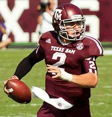 A picture of Johnny Manziel while holding a football during a game.