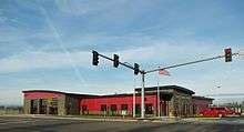 The Jones Farm fire station is one story tall with gray concrete blocks and red colored brick on the exterior.