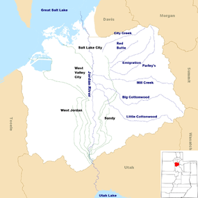 A map of Salt Lake County showing a river running from a lake in the south to a lake in the north.  Canals branch off the river.  Other creeks enter from the east. In the lower right corner is a map of Utah with a colored-in portion in the northern middle showing the location of Salt Lake County.