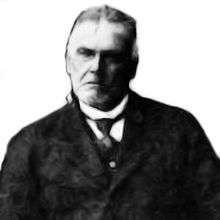 Black and white photo of a man wearing a suit