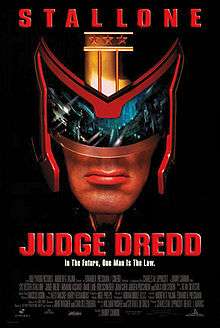 A headshot picture of Judge Dredd, wearing his helmet and a view of Mega City One inside his glasses of the helmet, below him, there are the film's slogan, title, credits and release date.