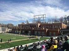A brick structure at the end of an American football field.