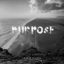 Justin Bieber down below. Standing on a mountain and watching the sea with no shirt on. Top on the middle, there's  a title that says "PURPOSE". Down below, Justin Bieber's name is shown darkly.