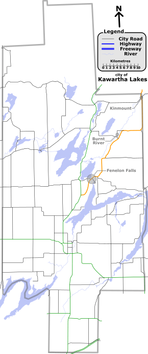 "A map with various coloured lines representing different types of roadways. In deep-blue are provincial highways. In black are other Kawartha Lakes numbered roads. In orange, and thicker than the other lines is Kawartha Lakes Road 121. Lakes and rivers are light-blue."