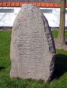 A large grey stone with inscription