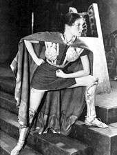 Hepburn, a young woman, dressed in a short tunic and armour, acting in a play.