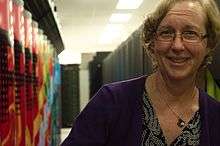 Kathy Yelick in front of Hopper Cray XE6