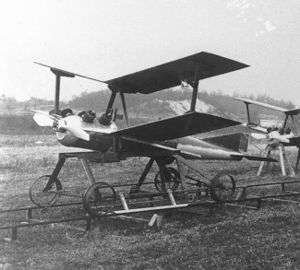 a small biplane aircraft resting on a pair of rails