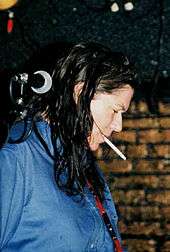 Kim Deal standing next to a microphone