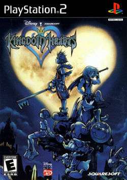 Artwork of a vertical rectangular box. Five people with weapons stand and sit atop a building ledge. A night sky with a heart-shaped moon is in the background. The words "PlayStation 2" and "Kingdom Hearts" are in the top left corner.